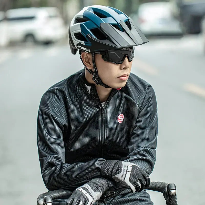ROCKBROS electric bicycle helmet worn by a cyclist in sunglasses, showcasing its breathable and safe design on the road.