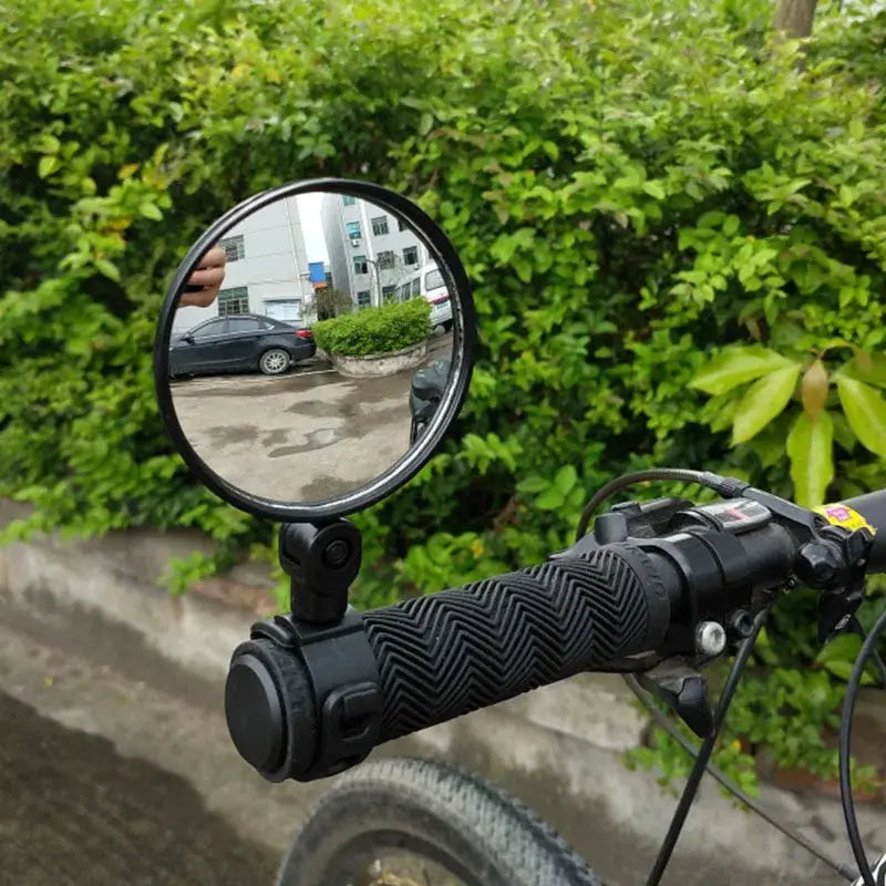 Electric scooter rear view mirror installed on handlebars providing wide-angle view for safety.