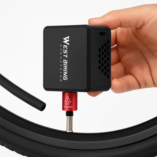 WEST BIKING Mini Electric Bike Pump in hand, connecting to bike tire for inflation.