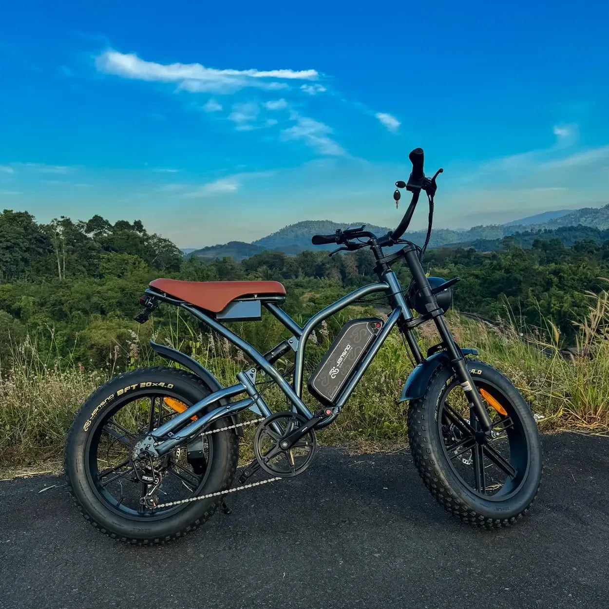Jansno X50 Electric Bike 750W motor parked on a scenic path with mountains in the background.