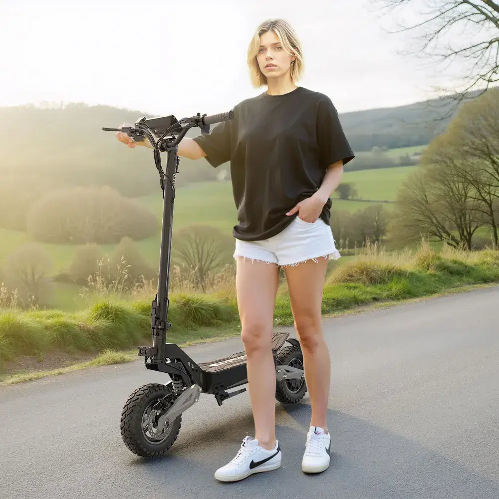 900W Foldable Off-Road Electric Scooter in use on a scenic road.