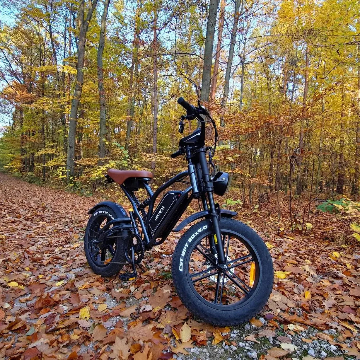 Jansno X50 Electric Bike 750W motor in autumn forest, showcasing all-terrain capabilities and fat tires.