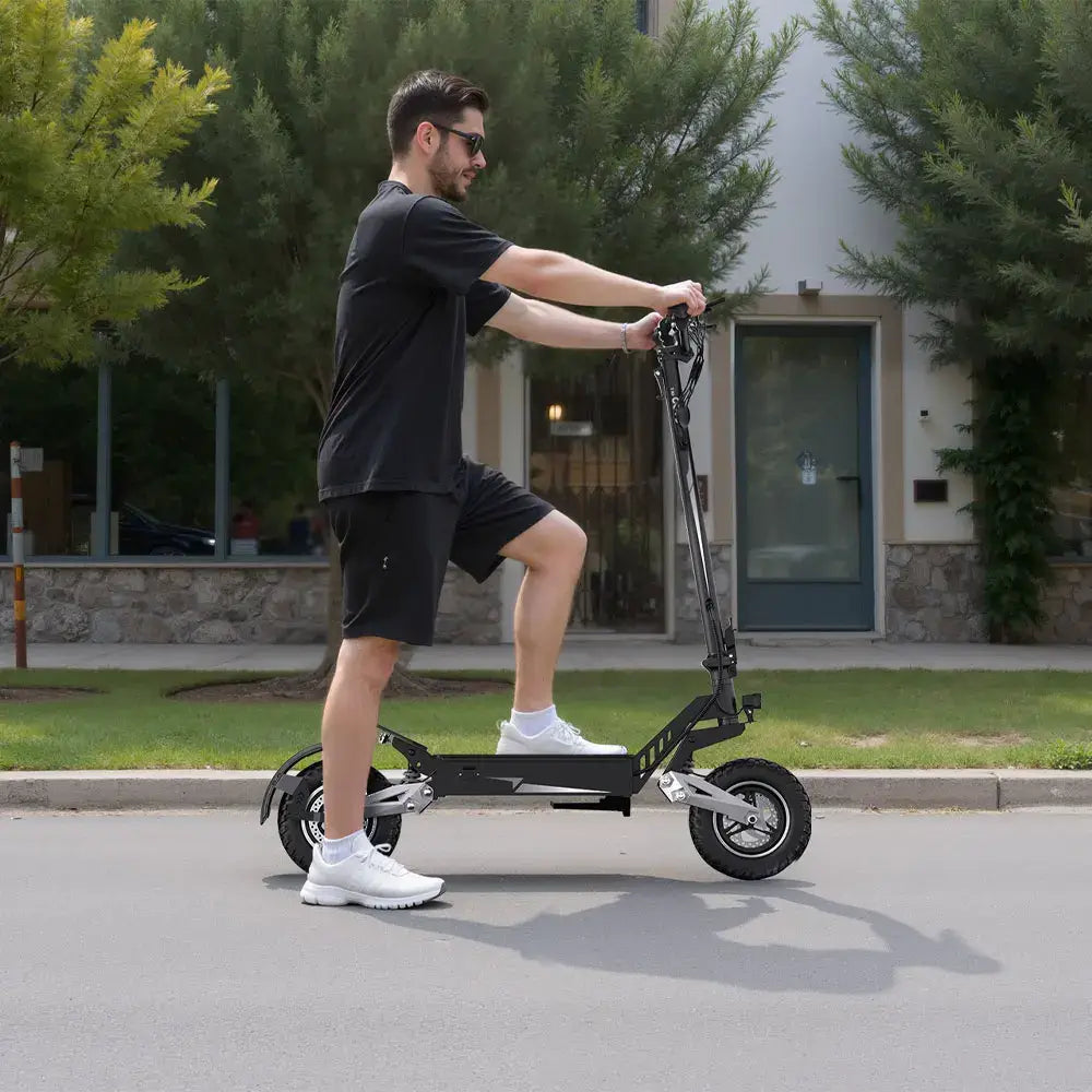 900W Foldable Off-Road Electric Scooter being ridden on a street by a man in casual attire.