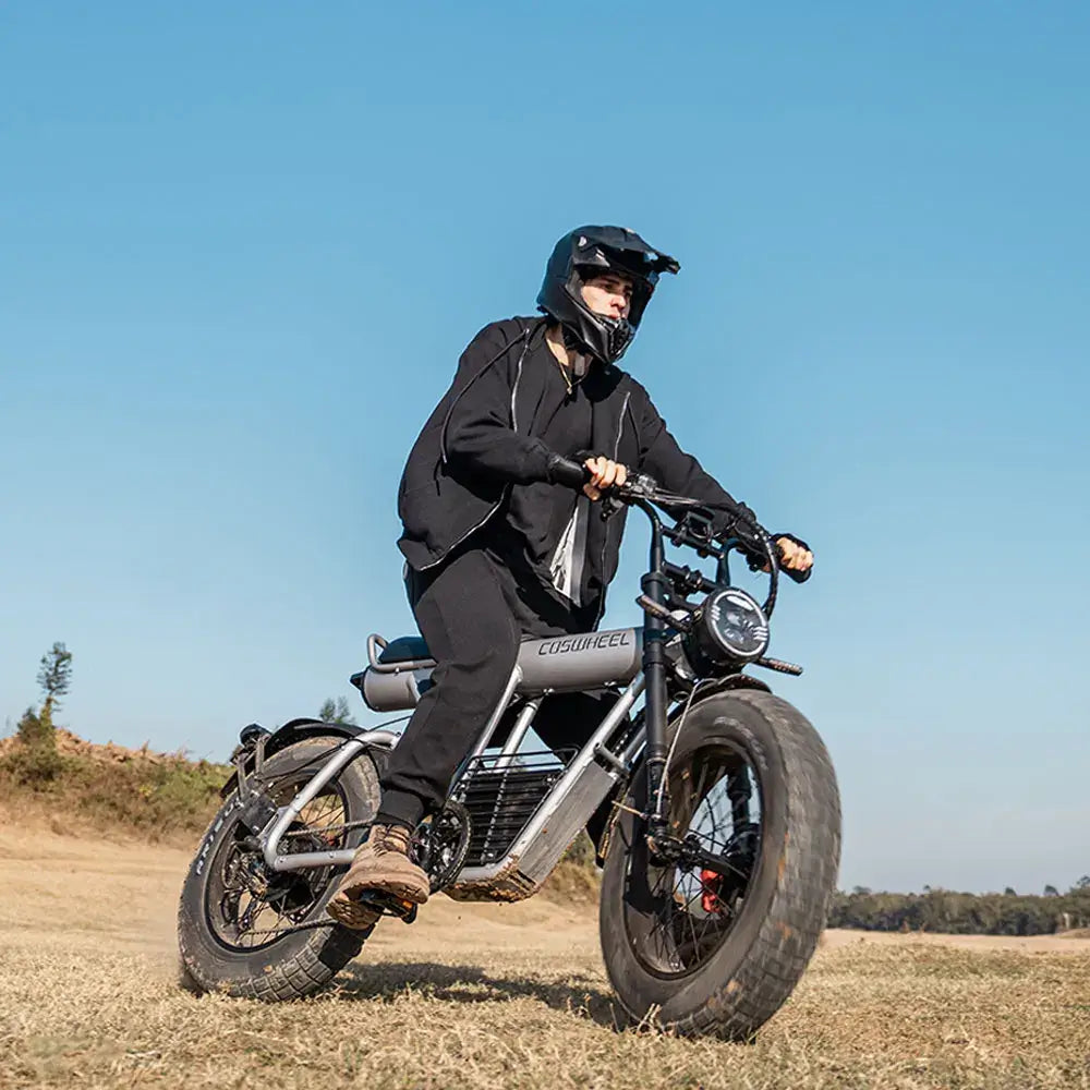 Coswheel Electric Bike CT20S 2000W rider in action on diverse terrain with fat tires.