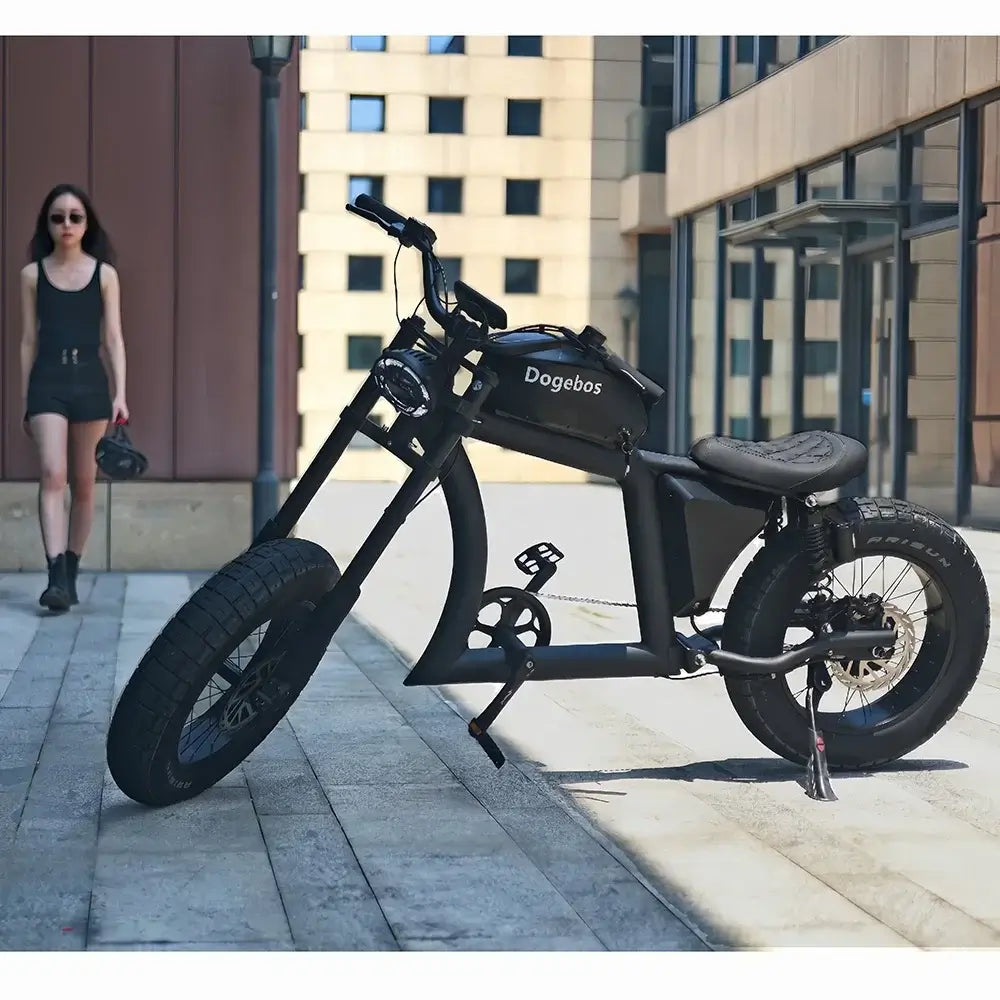 2024 electric bike with fat tires parked in urban setting with woman walking by.