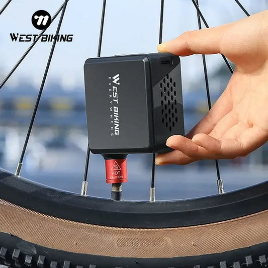 WEST BIKING Mini Electric Bike Pump inflating a tire, showcasing its compact design and powerful performance.